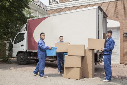 Removal crew carrying items through a narrow stairwell in Dulwich