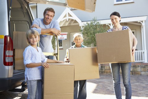 Moving crew handling furniture and boxed belongings